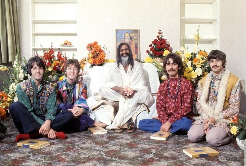 A photo of the Maharishi Mahesh Yogi and the Beatles during their visit to Rishikesh, India. Original source: Brown History (Substack), brownhistory.substack.com/p/the-maharishi-and-the-beatles-the.